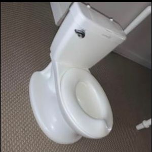 Toddler potty training chair with spill guard